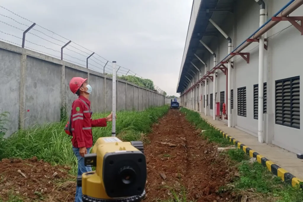 Sinar Alam Cakrabuana Worker Mapping the Area for Rain Water Absorption Facility